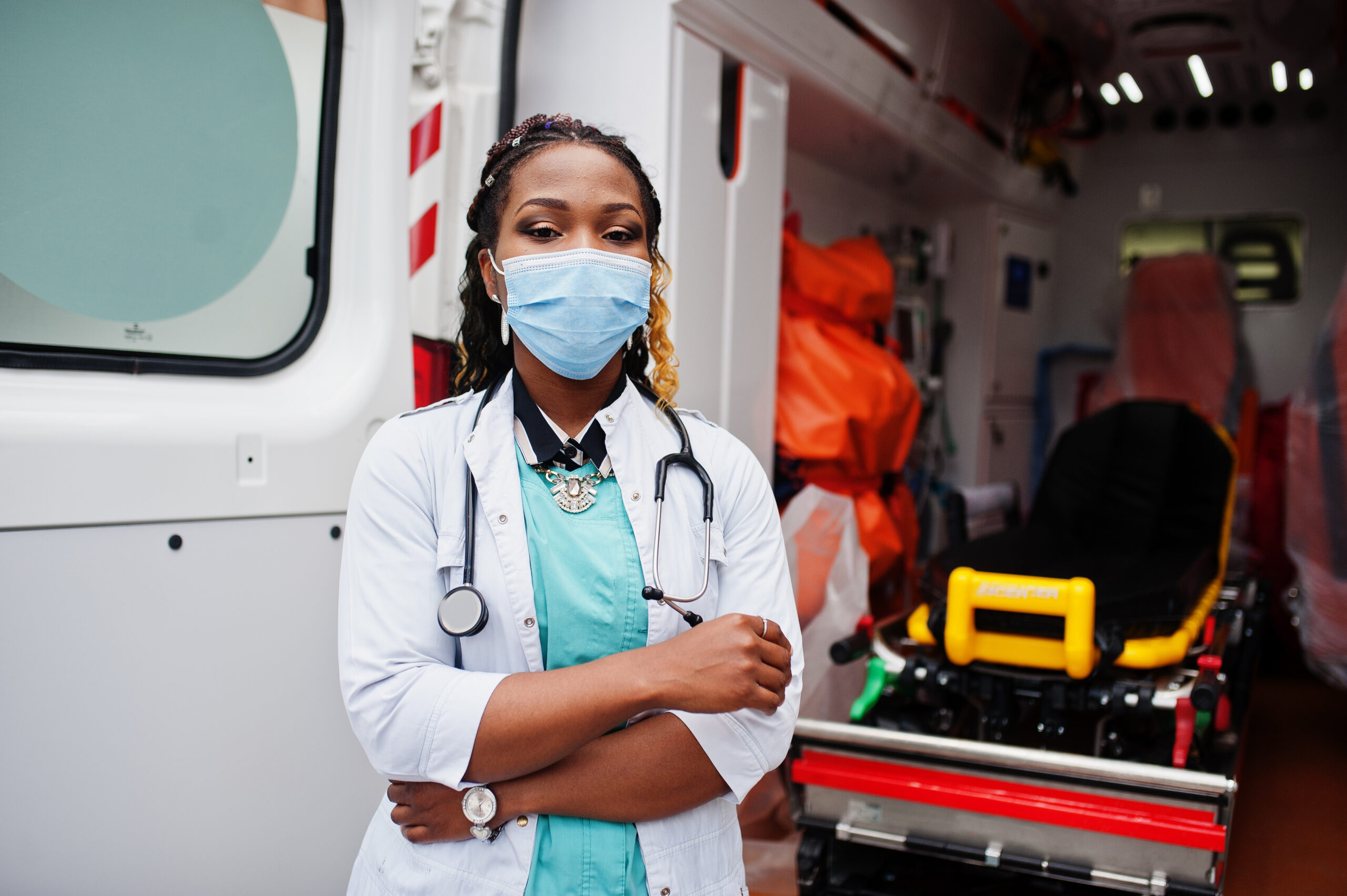 Female healthcare professional wearing mask and stethoscope standing in ambulance representing MRCOG Exam Results 2026